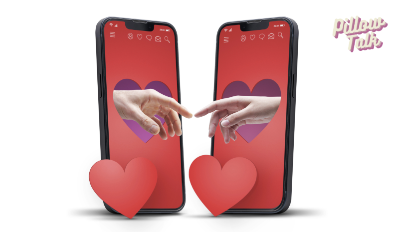 An image of 2 cell phones facing each other. Each with a heart in the middle of the screen and hands reaching out to touch each one another from the center of the heart in a flirty manner.